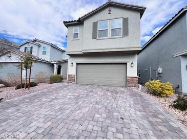 Charming two-story home with a stone-accented facade and well-manicured landscaping at 7708 Mojave Wind Ave, Las Vegas, NV 89113
