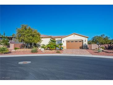 Charming single-story home with desert landscaping, a brick driveway, and a two-car garage at , Las Vegas, NV 89131