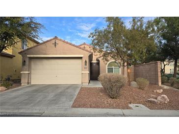 Charming single-story home with a two-car garage, neutral stucco, and well-maintained desert landscaping at 8824 Martin Downs Pl, Las Vegas, NV 89131