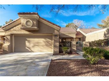 Charming single-story home featuring a two-car garage, well-maintained landscaping, and a walkway leading to the entrance at 8920 Litchfield Ave, Las Vegas, NV 89134
