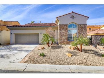 Charming home with stone accents, desert landscaping, and a two-car garage at 1223 Casa Palermo Cir, Henderson, NV 89011