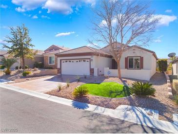 Charming single-story home featuring manicured landscaping and a two-car garage at 2633 Flare Star Dr, Henderson, NV 89044