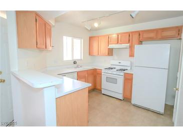 Bright kitchen featuring white appliances and light wood cabinets, creating a clean and functional space at 4555 E Sahara Ave # 231, Las Vegas, NV 89104