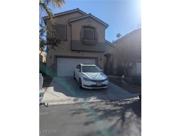 Two-story home with a driveway and two-car garage in a residential neighborhood at 4970 Copperlyn St, Las Vegas, NV 89122