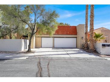 Charming two-story home featuring a two-car garage, red-tiled roof, and desert landscaping at 5102 Tennis Ct, Las Vegas, NV 89120