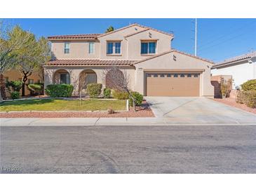 Charming two-story home featuring a red tile roof, attached garage, and well-manicured lawn at 6337 Black Mane Way, North Las Vegas, NV 89081