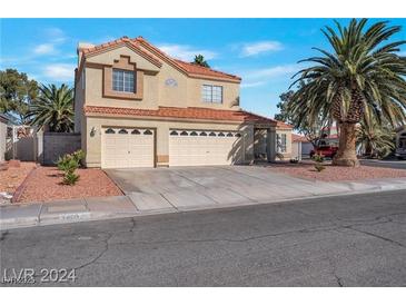 Charming two-story home features a three-car garage and mature landscaping, including palm trees at 7400 Wheat Grass Ct, Las Vegas, NV 89129