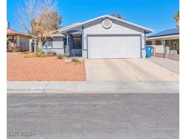 Charming single-story home featuring a well-maintained front yard and a two-car garage at 7436 Lattimore Dr, Las Vegas, NV 89128