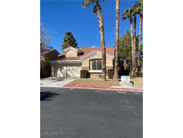 Charming single-story home featuring a well-maintained yard and a two-car garage at 9286 Blue Flax Pl, Las Vegas, NV 89148