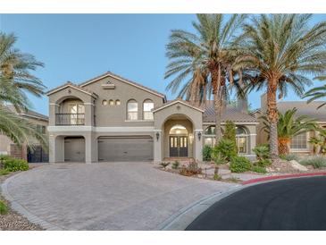 Stunning two-story home with tile roof, palm trees, arched entry, and brick driveway at 11158 Antonine Wall Ct, Las Vegas, NV 89141