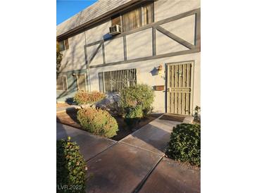 Charming townhouse exterior featuring a well-maintained facade and landscaped front yard at 156 Greenbriar Townhouse Way, Las Vegas, NV 89121