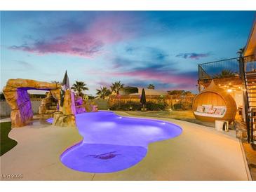 Backyard pool with a grotto, slide, and comfortable outdoor seating at 200 E Desert Rose Dr, Henderson, NV 89015