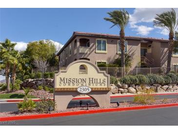 Exterior view of Mission Hills Condominiums featuring lush landscaping, a palm tree, and sign at 2305 W Horizon Ridge Pkwy # 3324, Henderson, NV 89052