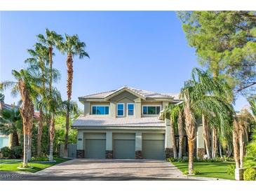 Inviting two-story home featuring a 3 car garage and lush tropical landscaping at 2309 Prometheus Ct, Henderson, NV 89074