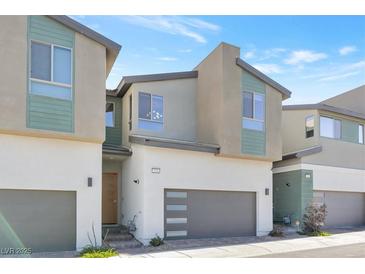 Modern townhome featuring neutral colors, a two-car garage and manicured landscaping at 2536 Catallo St, Henderson, NV 89044