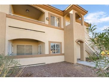 Inviting condominium exterior featuring stucco walls, arched entryways, and multiple levels of living at 3400 Cabana Dr # 1084, Las Vegas, NV 89122