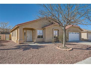 Charming single-story home featuring a well-maintained front yard and a two-car garage at 3531 Barrel Bronco Ct, North Las Vegas, NV 89032