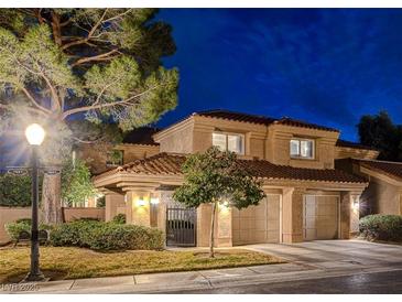 Charming two-story stucco home with a tile roof, well-manicured landscaping, and a two-car garage at 7607 Boca Raton Dr, Las Vegas, NV 89113