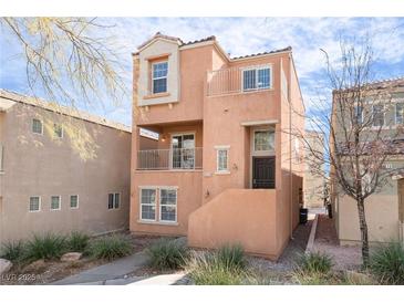 Charming three-story home with stucco exterior, balconies, and low-maintenance landscaping at 9124 Palatial Palette Ct, Las Vegas, NV 89149