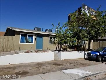 Modest single-story home featuring a light-colored exterior and a small front yard with desert landscaping at 333 N 13Th St, Las Vegas, NV 89101