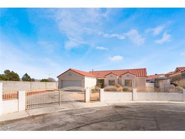 Charming single-story home featuring a red tile roof and gated front yard at 4142 Forestville St, North Las Vegas, NV 89032