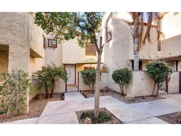 Charming condo featuring a private patio area with mature landscaping and a welcoming entrance at 5029 Spencer St # A, Las Vegas, NV 89119