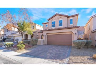 Charming two-story home featuring a well-manicured lawn and a two-car garage at 589 Via Medici, Henderson, NV 89011