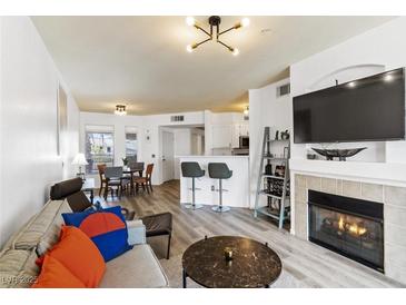 Inviting living room featuring fireplace, contemporary furnishings, and an open floor plan at 7115 S Durango Dr # 308, Las Vegas, NV 89113