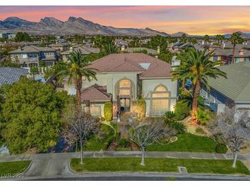 Stunning two-story home with mature landscaping, mountain views, and a grand entrance at 9616 Grand Isle Ln, Las Vegas, NV 89144