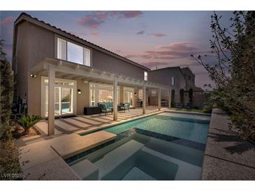 Beautiful backyard pool and patio area, perfect for outdoor entertaining with covered seating at 9781 Arcadian Estate Ct, Las Vegas, NV 89141