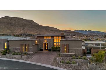 Stunning single-story home with a modern design, beautiful landscaping, and a mountain view at 10096 Amethyst Hills St, Las Vegas, NV 89148