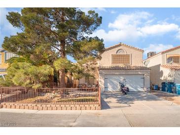 Charming two-story home with a well-manicured front yard and a convenient two-car garage at 2245 Saint Paul Way, Las Vegas, NV 89104