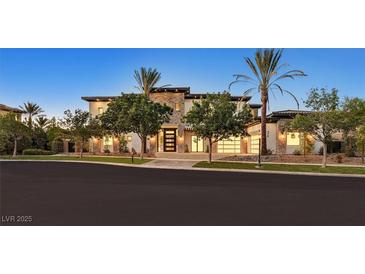 Striking two-story home with desert landscaping, stone accents, and a three-car garage at 34 Vintage Canyon St, Las Vegas, NV 89141