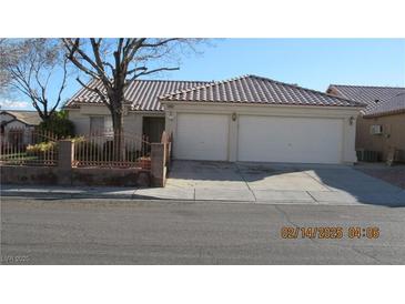 Charming single-story home featuring a terracotta tile roof, two-car garage, and a well-maintained front yard at 3805 Vidalia Ave, North Las Vegas, NV 89031