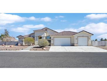 Well-maintained single-story home with a three-car garage and beautiful desert landscaping at 6120 Farm Rd, Las Vegas, NV 89131