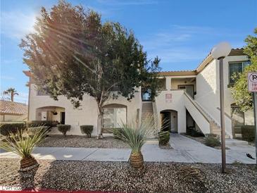 Charming two-story condo with desert landscaping and stucco exterior offers a welcoming entrance at 6701 Squaw Mountain Dr # 201, Las Vegas, NV 89130