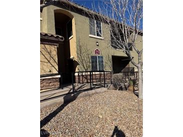 Well-maintained building exterior with private entrance, a welcoming walkway and desert landscaping at 6868 Sky Pointe Dr # 1087, Las Vegas, NV 89131