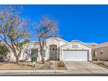 Charming single-story home with a two-car garage and well-maintained desert landscaping at 1590 Raining Hills St, Henderson, NV 89052