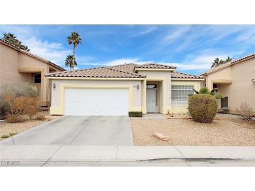 Charming single-story home featuring a well-maintained front yard and a two-car garage at 7858 Nookfield Dr, Las Vegas, NV 89147