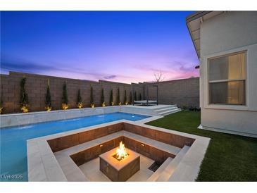 Inviting pool area featuring a fire pit, tanning deck, and elegant landscaping perfect for relaxation and entertaining at 11991 Rockview Point St, Las Vegas, NV 89138