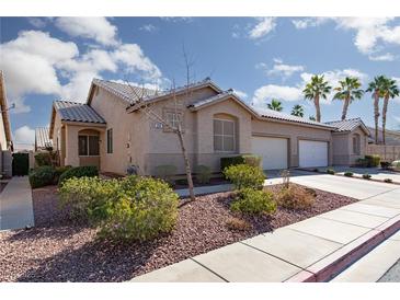 Charming single-story home featuring a well-maintained yard and three-car garage at 214 Roxborough St, Henderson, NV 89074