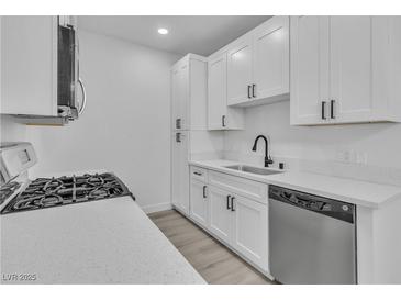 Modern kitchen featuring white cabinets, stainless steel appliances, and white countertops at 3318 N Decatur Blvd # 1035, Las Vegas, NV 89130