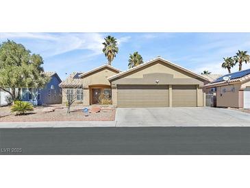 Charming single-story home featuring a low-pitched roof, desert landscaping, and an attached two-car garage at 3514 Jordan Ln, North Las Vegas, NV 89032