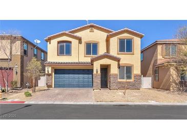 Charming two-story home with a blue garage door and low maintenance landscaping at 4116 Free Bird Crest Ave, North Las Vegas, NV 89081