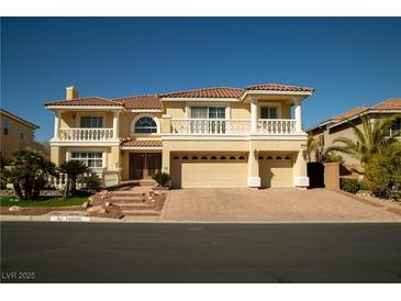 Stunning two-story home featuring a tile roof, dual balconies, and a three-car garage at 4384 Grey Spencer Dr, Las Vegas, NV 89141