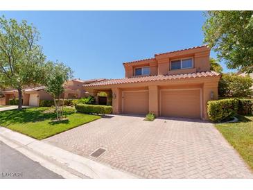 Charming two-story home featuring a brick driveway, desert landscaping, and a two-car garage at 5101 Breakers Ln, Las Vegas, NV 89113