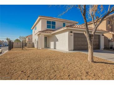 Charming two-story home with a desert landscape, a two-car garage, and a welcoming entrance, bathed in bright sunlight at 5357 Hammond Ct, Las Vegas, NV 89110