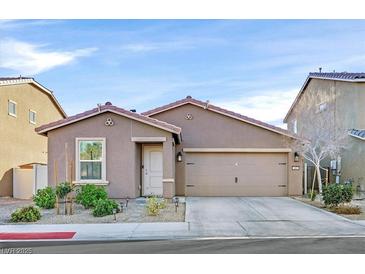 Charming single-story home with a well-maintained front yard and a two-car garage at 101 Deseo Ct, North Las Vegas, NV 89031