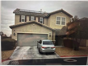 Inviting two-story home with a two car garage, solar panels, and a well-maintained front yard at 10355 Sipple St, Las Vegas, NV 89141