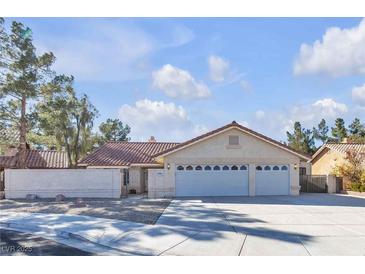 Charming single-story home with a three-car garage and desert landscaping at 1709 Guthrie Dr, Las Vegas, NV 89117